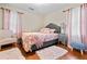 Inviting bedroom with a plush gray bed, stylish pink accents, and soft lighting creates a cozy atmosphere at 116 Lyle Rd, Goose Creek, SC 29445