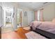 Inviting bedroom with a plush gray bed, stylish pink accents, and a bathroom visible through an open doorway at 116 Lyle Rd, Goose Creek, SC 29445