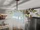 Modern dining room chandelier with foliage hanging from the wooden fixture above at 116 Lyle Rd, Goose Creek, SC 29445