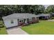 Well-maintained brick and vinyl ranch home featuring a lush green lawn and mature shade trees at 116 Lyle Rd, Goose Creek, SC 29445
