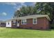 Well-maintained brick and vinyl ranch home featuring a lush green lawn and mature shade trees at 116 Lyle Rd, Goose Creek, SC 29445
