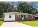 Charming brick and vinyl ranch-style home with a well-manicured lawn and mature trees creating a serene atmosphere at 116 Lyle Rd, Goose Creek, SC 29445