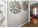 Hallway features modern windmill wall decor and wood flooring leading to a bedroom at 116 Lyle Rd, Goose Creek, SC 29445