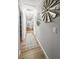 Spacious hallway with patterned rug, wood floors and decorative windmill wall hangings at 116 Lyle Rd, Goose Creek, SC 29445
