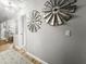 Hallway features modern windmill wall decor, a patterned rug, and wood flooring at 116 Lyle Rd, Goose Creek, SC 29445