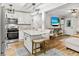 Eat-in kitchen with granite countertops and island seating next to the living area at 116 Lyle Rd, Goose Creek, SC 29445