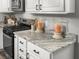 Close up of the granite kitchen countertops with cabinets and a black range at 116 Lyle Rd, Goose Creek, SC 29445