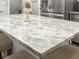 Close up on a kitchen island with a beautiful marbled countertop and seating for two at 116 Lyle Rd, Goose Creek, SC 29445