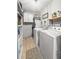 Functional laundry room featuring a side-by-side washer and dryer, built-in shelving, and ample storage space at 116 Lyle Rd, Goose Creek, SC 29445