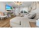 Cozy living room featuring stylish decor, wood floors, and a view of the front door and window at 116 Lyle Rd, Goose Creek, SC 29445