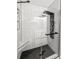 A modern shower with glass doors and white subway tiles featuring sleek black fixtures at 116 Lyle Rd, Goose Creek, SC 29445
