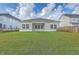 Exterior backyard view featuring a covered patio and spacious yard at 117 Oyster Tide Ave, Summerville, SC 29485