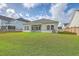 A beautifully landscaped backyard featuring lush green grass, a charming patio, and a secure fence for privacy and enjoyment at 117 Oyster Tide Ave, Summerville, SC 29485