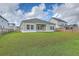 A spacious backyard with green grass, a cozy patio, and privacy fence, perfect for outdoor entertaining and relaxation at 117 Oyster Tide Ave, Summerville, SC 29485