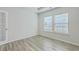 Bright bedroom featuring wood-look flooring, recessed lighting, and natural light from the large windows at 117 Oyster Tide Ave, Summerville, SC 29485