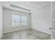 Bright bedroom featuring wood-look flooring, recessed lighting, and natural light from the large windows at 117 Oyster Tide Ave, Summerville, SC 29485