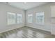 Bright dining room featuring natural light from the large windows and wood-look floors at 117 Oyster Tide Ave, Summerville, SC 29485