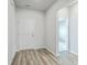 Bright entryway with wood-look flooring, white walls, and view to adjacent room with carpet at 117 Oyster Tide Ave, Summerville, SC 29485
