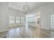 Bright living room with hardwood floors, open layout with view to kitchen, and abundant natural light from multiple windows at 117 Oyster Tide Ave, Summerville, SC 29485