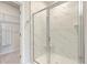 Shower with marble wall-surround, glass doors, and built-in niche at 117 Oyster Tide Ave, Summerville, SC 29485