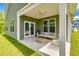 Relaxing covered patio with comfortable seating, a ceiling fan, and backyard access at 119 Crosscut Ln, Summerville, SC 29486