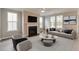 Cozy living room with fireplace, large windows, and comfortable seating arrangement at 119 Crosscut Ln, Summerville, SC 29486