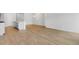 Open-concept living room featuring wood floors and white walls connecting to kitchen, providing an airy feel at 119 Lefton Lndg, Summerville, SC 29485