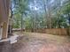 Picturesque backyard featuring a lush lawn, mature trees, and a wooden fence for privacy at 119 Scottswood Dr, North Charleston, SC 29418