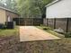 Backyard concrete pad and fenced area, surrounded by grass and landscaping, ready for outdoor entertaining at 119 Scottswood Dr, North Charleston, SC 29418
