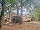 Spacious backyard featuring a screened-in porch, mature trees, and ample room for outdoor activities at 119 Scottswood Dr, North Charleston, SC 29418