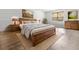 Well-furnished bedroom with a beautiful wooden bed, warm lighting, and a light colored wood floor at 119 Scottswood Dr, North Charleston, SC 29418
