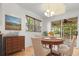 Dining room features hardwood floors and a sliding door to the screened-in porch at 119 Scottswood Dr, North Charleston, SC 29418