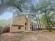 Back of home featuring a spacious lawn, a screened in porch, and mature trees at 119 Scottswood Dr, North Charleston, SC 29418