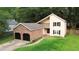 Charming two-story home features a brick garage, a well-maintained lawn, and classic curb appeal at 119 Scottswood Dr, North Charleston, SC 29418