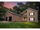Inviting two-story home with brick accents and a spacious two-car garage under a colorful dusk sky at 119 Scottswood Dr, North Charleston, SC 29418