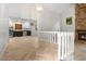Open-concept living room with stone fireplace, wood floors, and adjacent kitchen area at 119 Scottswood Dr, North Charleston, SC 29418
