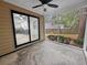A screened porch that overlooks a well maintained yard, with a glimpse of the kitchen through glass doors at 119 Scottswood Dr, North Charleston, SC 29418