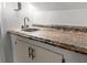 Close-up on wet bar featuring stone countertop and white cabinets at 119 Scottswood Dr, North Charleston, SC 29418