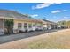 Backyard view of multiple homes featuring tan siding, well-kept yards and screened-in porches at 127 Manning Ct, Summerville, SC 29485
