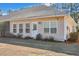Backyard featuring a tan siding home with multiple windows and a glass paneled back door at 127 Manning Ct, Summerville, SC 29485