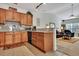 View of the kitchen featuring tile floors, granite countertops, and wood cabinetry at 127 Manning Ct, Summerville, SC 29485