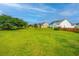 Lush backyard featuring green grass, mature trees, and partial fencing at 129 Dovetail Cir, Summerville, SC 29483