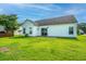 The home's backyard features a bright lawn and a white exterior that boasts a sliding glass door at 129 Dovetail Cir, Summerville, SC 29483