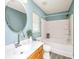 Clean bathroom with wood-look floors, a vanity, round mirror, and shower-tub combination at 129 Dovetail Cir, Summerville, SC 29483