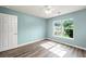 Cozy bedroom with light blue walls, wood-look floors, and natural light at 129 Dovetail Cir, Summerville, SC 29483