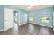 Spacious bedroom with wood-look floors and two windows for plenty of natural light at 129 Dovetail Cir, Summerville, SC 29483