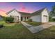 Charming one story home with white siding, manicured lawn, and concrete walkway at 129 Dovetail Cir, Summerville, SC 29483