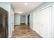 Hallway with LVP floors and neutral colored paint leading into a modern kitchen and pantry at 129 Dovetail Cir, Summerville, SC 29483