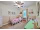 Cozy bedroom with a charming white iron bed frame, ceiling fan and playful decor at 1338 Addykay Pl, North Charleston, SC 29406