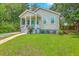 Charming home featuring a well-manicured lawn, complemented by lush greenery and a welcoming front porch at 1338 Addykay Pl, North Charleston, SC 29406